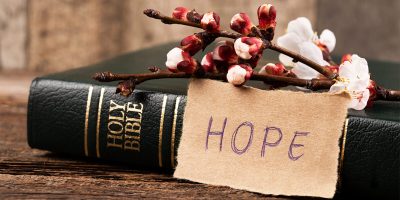 Photo of Bible with a note saying "Hope" and a flower for the blog post "When Hope Feels Lost"